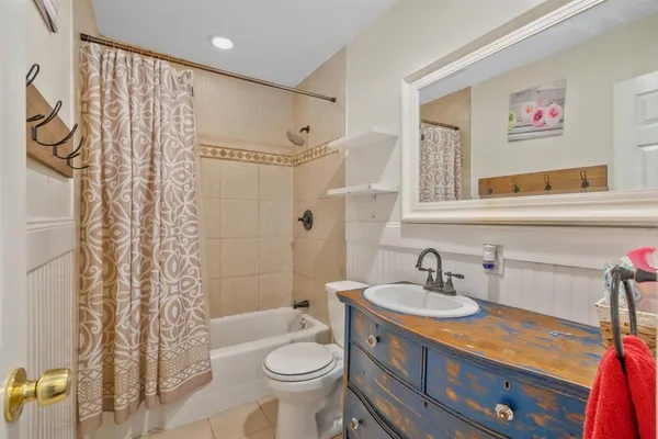 a bathroom with a sink toilet a shower and a mirror