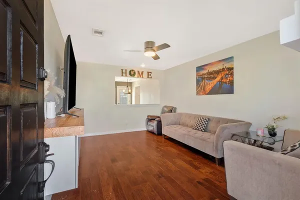 a living room with furniture and a flat screen tv