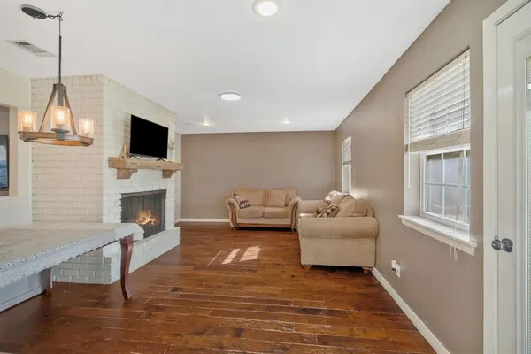 a living room with furniture a flat screen tv and a fireplace
