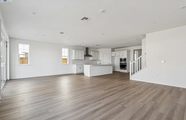 a view of a kitchen with wooden floor and a kitchen