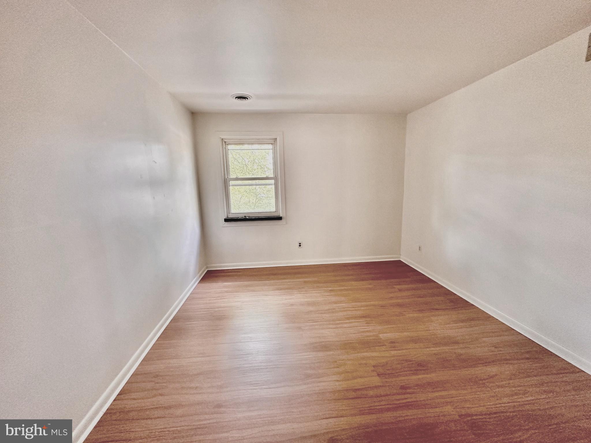110 East 40th Street, Unit 2 Wilmington, DE 19802 - Photo 3 of 7 a view of empty room with wooden floor and fan