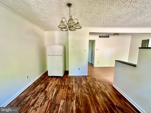 a view of a room with wooden floor and staircase