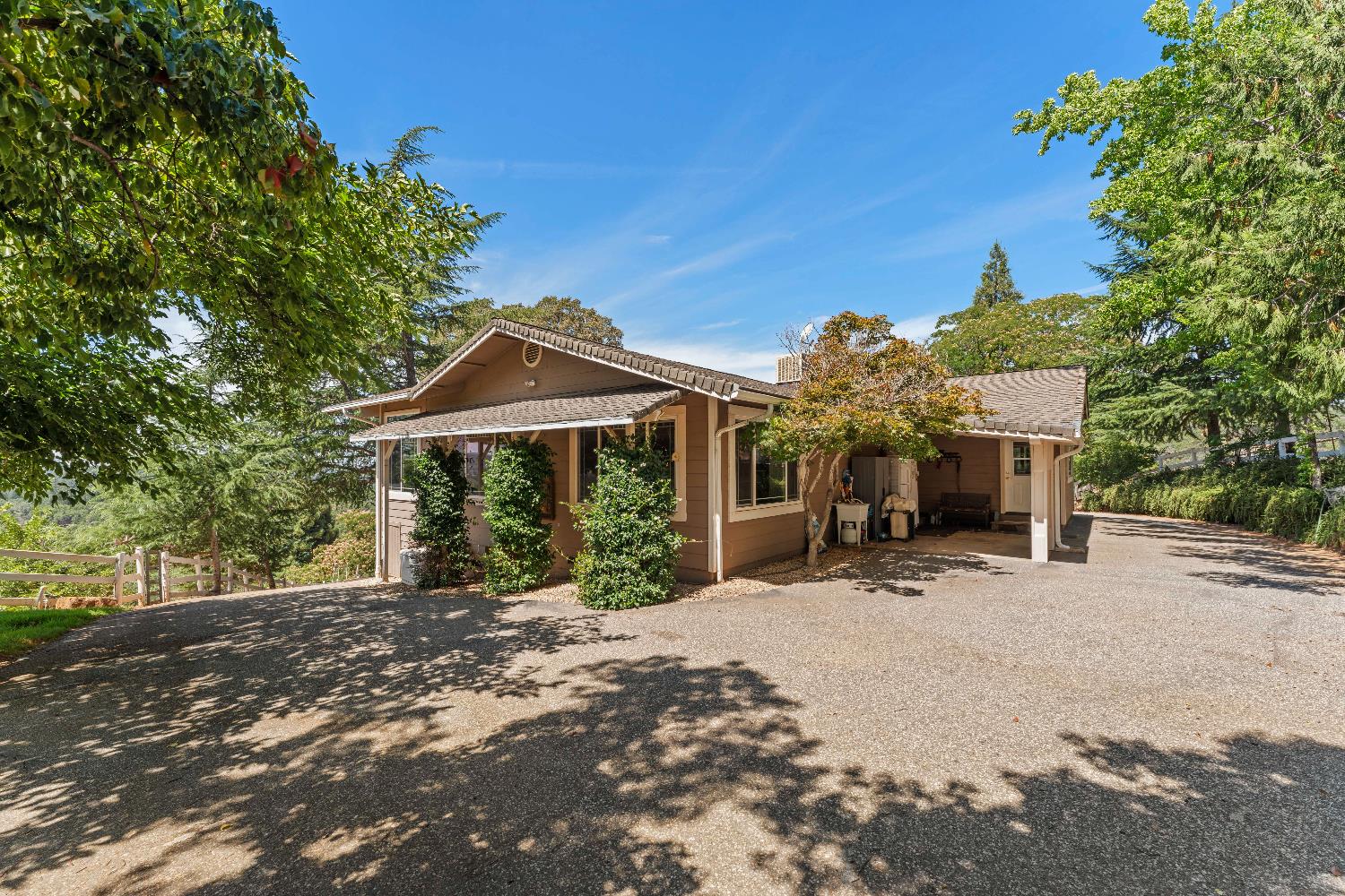 19699 McCourtney Road Grass Valley, CA 95949 - Photo 12 of 27 a front view of a house with a yard and garage