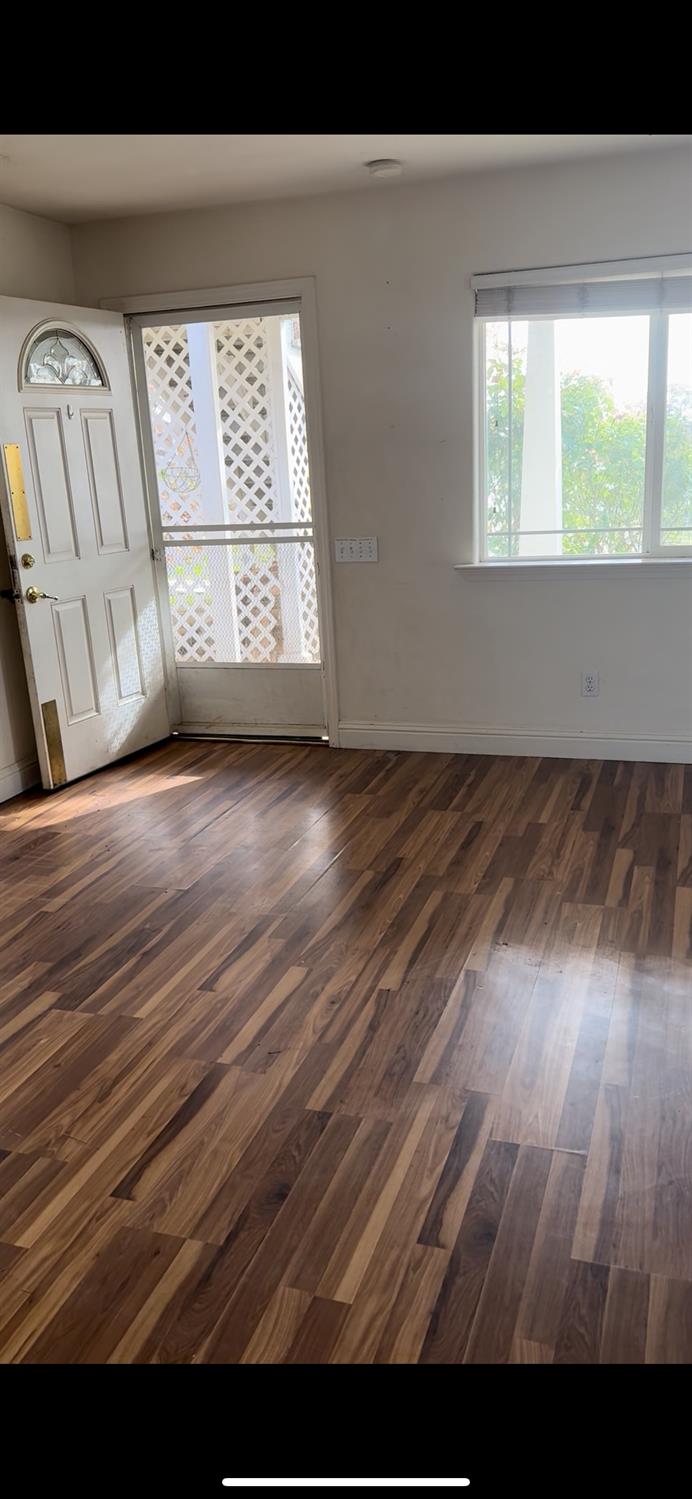 19699 McCourtney Road Grass Valley, CA 95949 - Photo 22 of 27 a view of an empty room with wooden floor and a window
