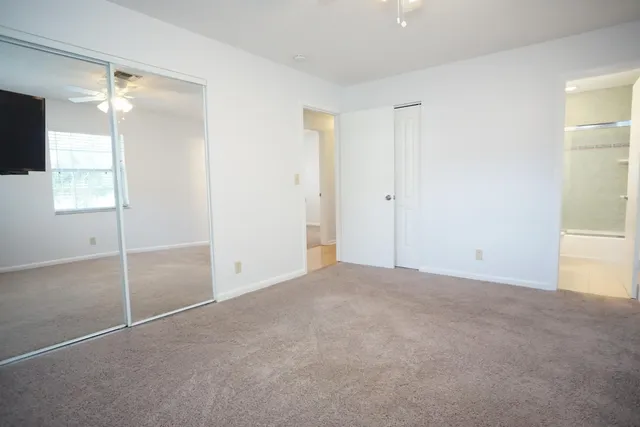 a view of an empty room with window and an empty room