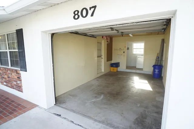 a view of a hallway with wooden shelves