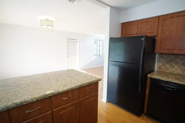 a kitchen with a refrigerator and a sink