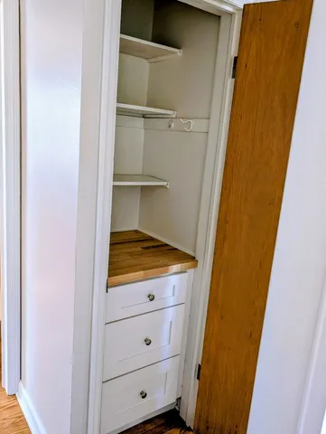 a view of an empty room with cabinet door