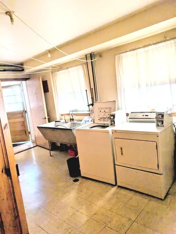 a view of kitchen with wooden floor and electronic appliances
