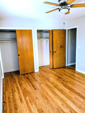 a view of an empty room with a ceiling fan