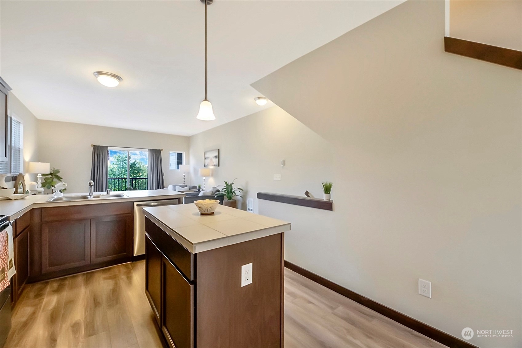 7100 Shinkle Place Southwest Seattle, WA 98106 - Photo 17 of 40 a kitchen with a sink a stove a refrigerator and blue walls with wooden floor
