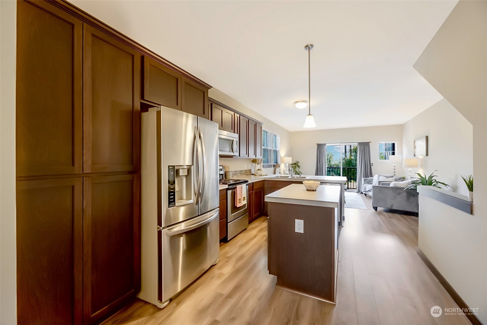 7100 Shinkle Place Southwest Seattle, WA 98106 - Photo 19 of 40 a kitchen with stainless steel appliances granite countertop a refrigerator a stove and a sink with wooden floor
