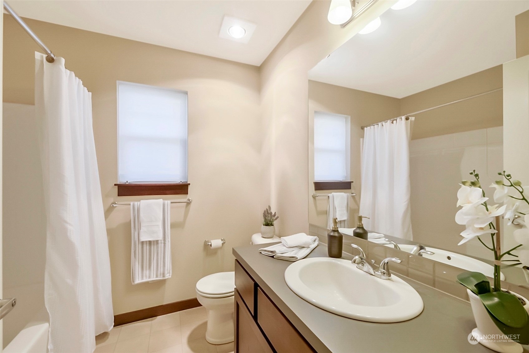 7100 Shinkle Place Southwest Seattle, WA 98106 - Photo 28 of 40 a bathroom with a toilet sink and mirror