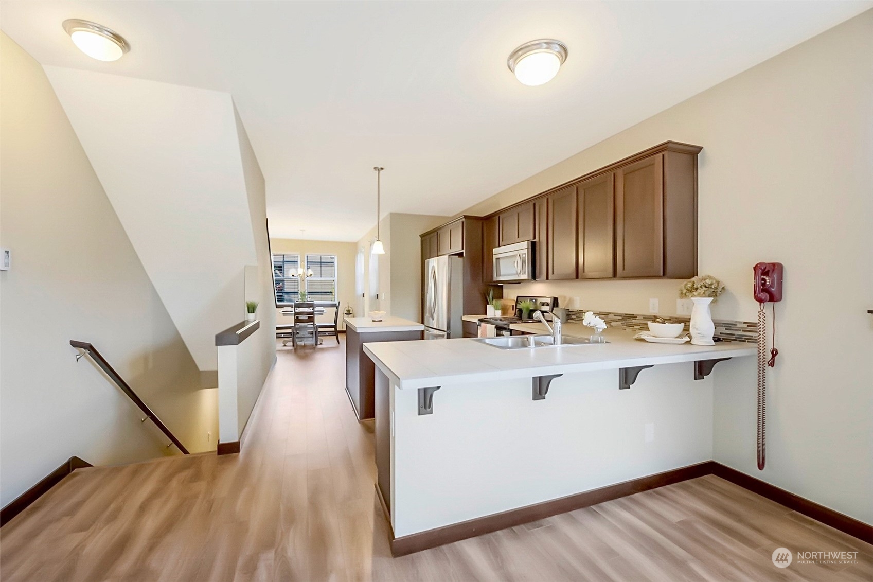 7100 Shinkle Place Southwest Seattle, WA 98106 - Photo 9 of 40 a view of a kitchen with wooden floor and electronic appliances