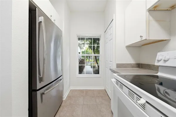 a view of a kitchen with a refrigerator and a sink