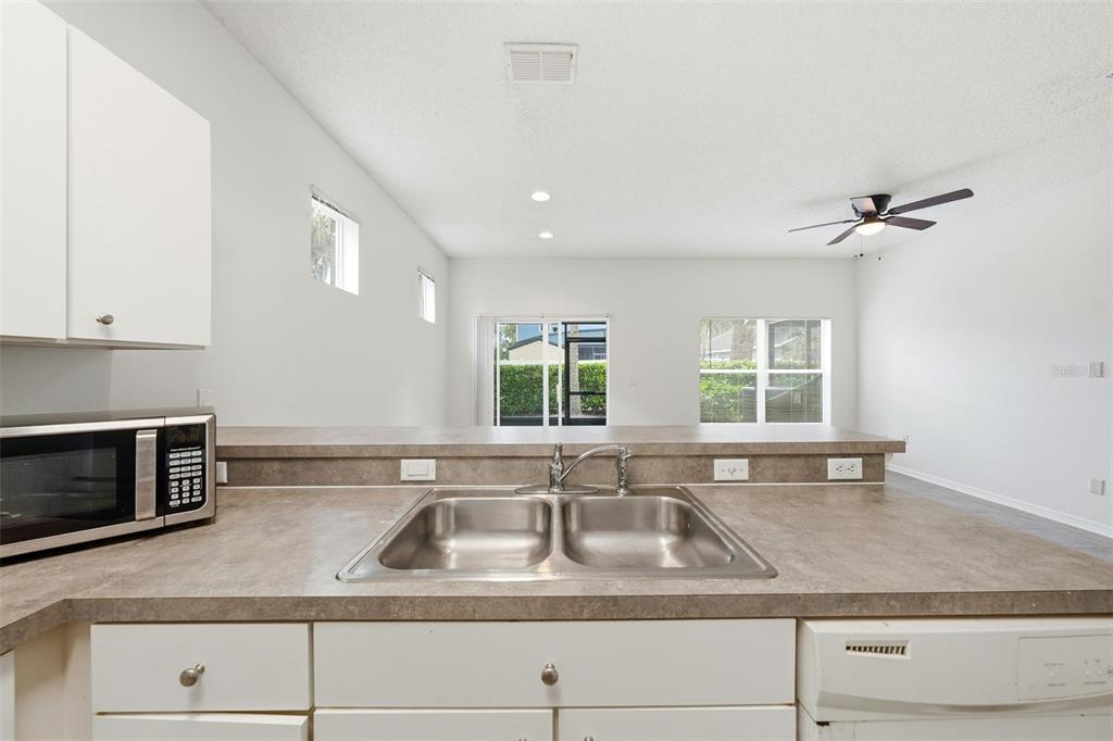 2227 Brancaster Circle Ocoee, FL 34761 - Photo 12 of 30 a kitchen with granite countertop a sink a stove and cabinets