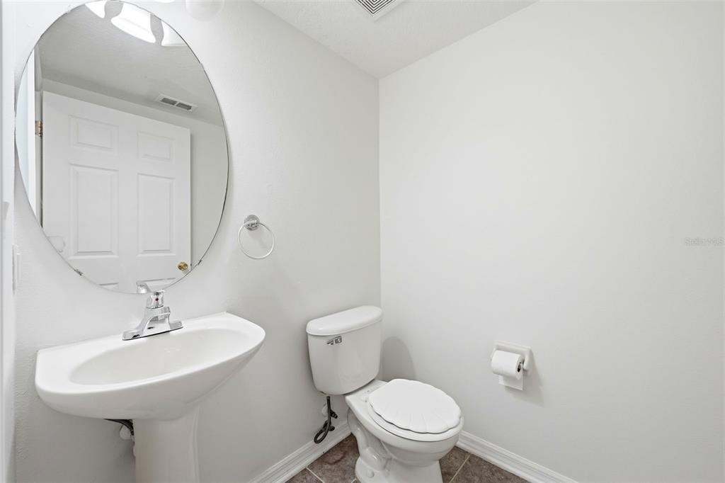 2227 Brancaster Circle Ocoee, FL 34761 - Photo 14 of 30 a bathroom with a toilet sink and mirror