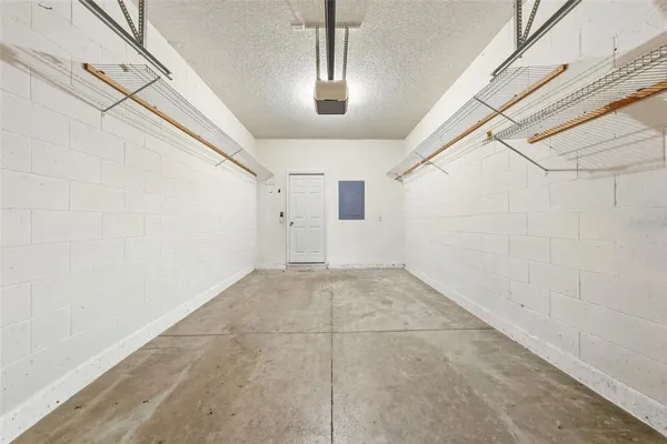 a view of a big room with wooden floor and windows