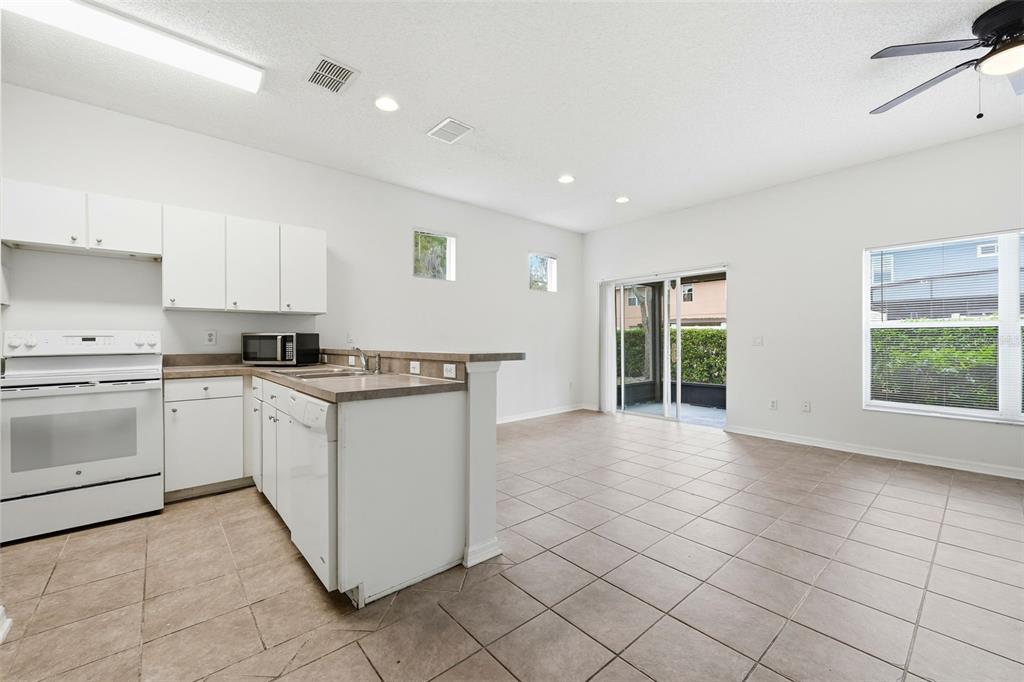 2227 Brancaster Circle Ocoee, FL 34761 - Photo 8 of 30 a kitchen with a stove a sink and a refrigerator