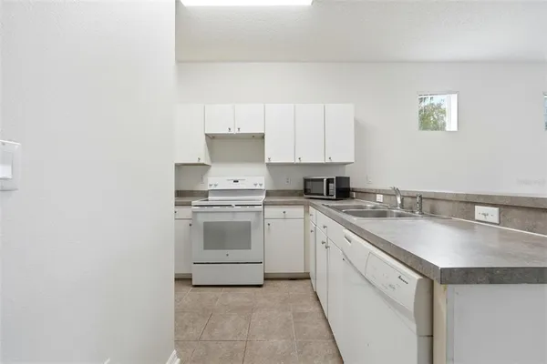 a kitchen with a sink stove and cabinets