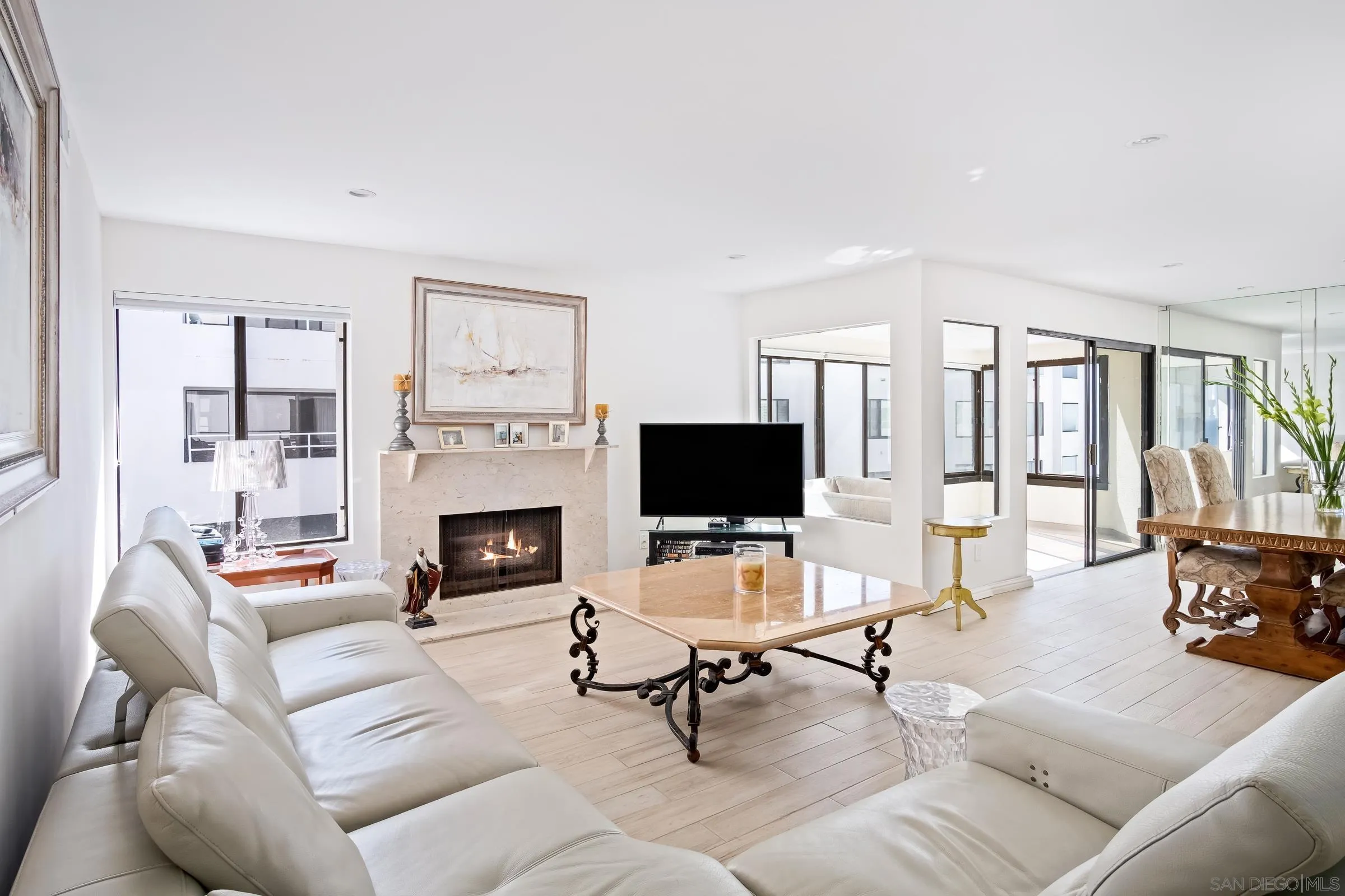 100 Coast Boulevard, Unit 302 La Jolla, CA 92037 - Photo 9 of 21 a living room with furniture a fireplace and a flat screen tv