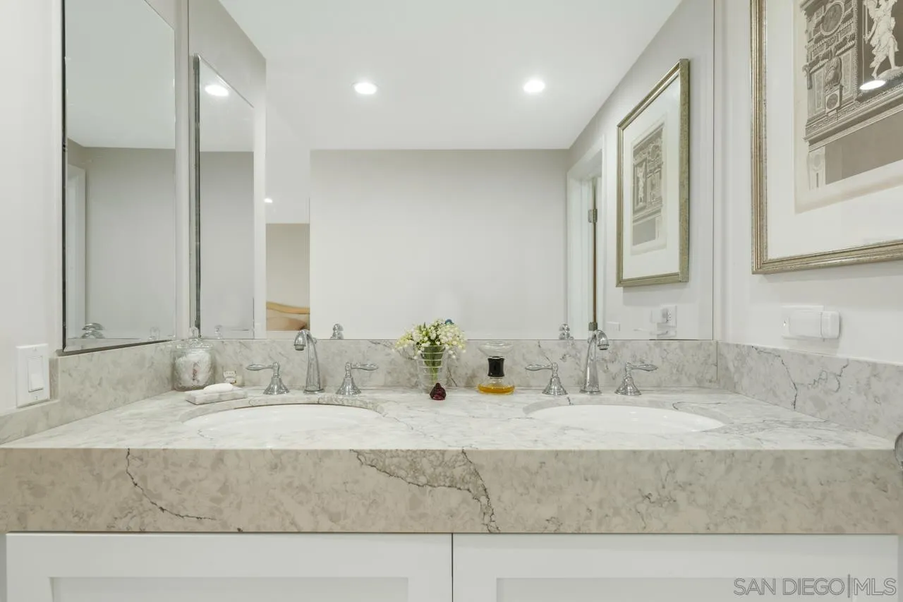 100 Coast Boulevard, Unit 302 La Jolla, CA 92037 - Photo 10 of 21 a bathroom with a granite countertop sink and a mirror