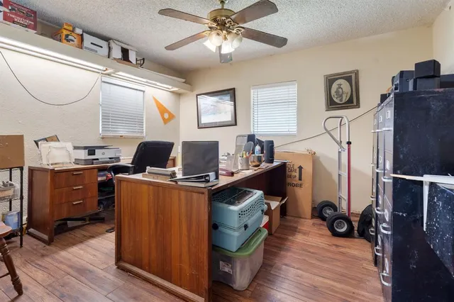a view of a workspace with furniture and a window