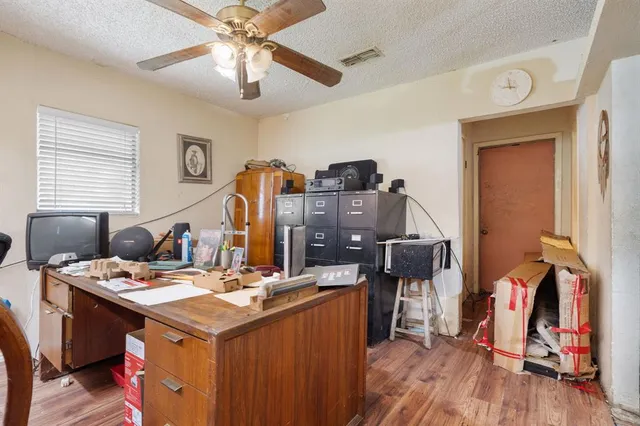 a kitchen that has a table chairs and wooden floor