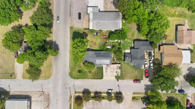 an aerial view of a house with a yard and garden