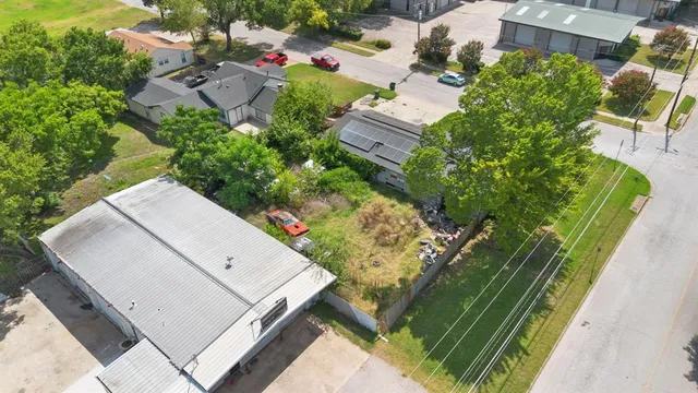 an aerial view of a residential houses with outdoor space
