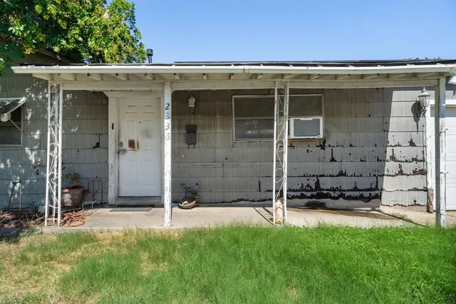a view of a patio with table and chairs