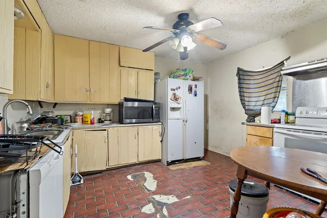 a kitchen with stainless steel appliances granite countertop a sink a stove and refrigerator
