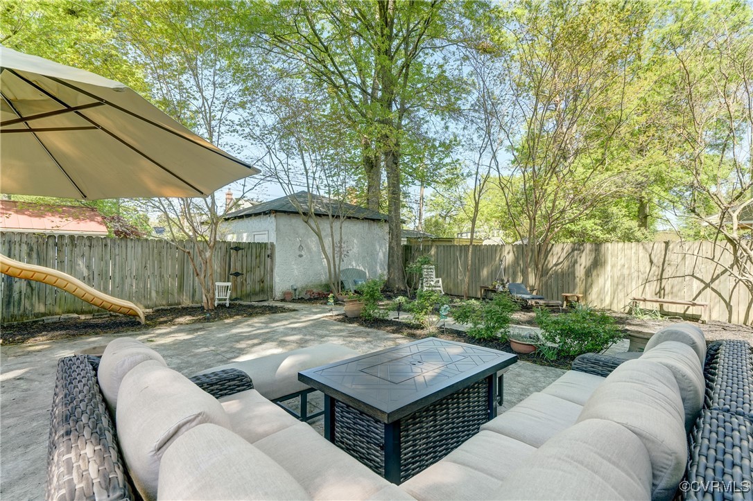 3906 Brook Road Richmond, VA 23227 - Photo 46 of 50 a view of a backyard with table and chairs under an umbrella
