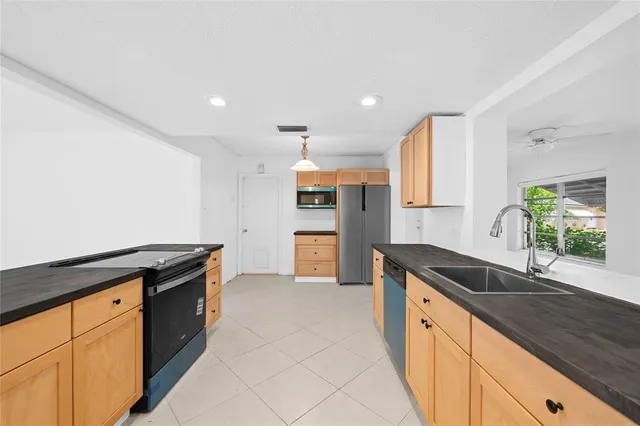 a kitchen with granite countertop a sink and a stove top oven
