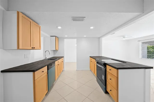 a kitchen with stainless steel appliances granite countertop a sink and a stove