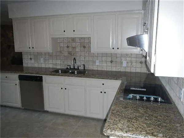 a kitchen with a sink and cabinets