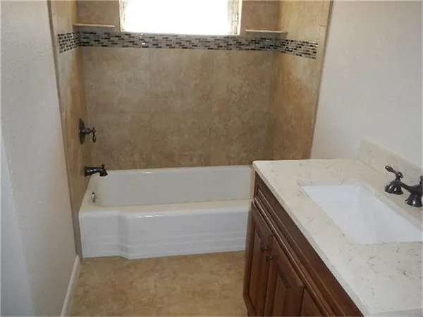 a bathroom with a bathtub and a sink