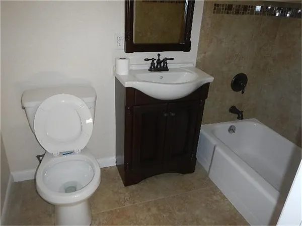 a bathroom with a sink toilet and a mirror