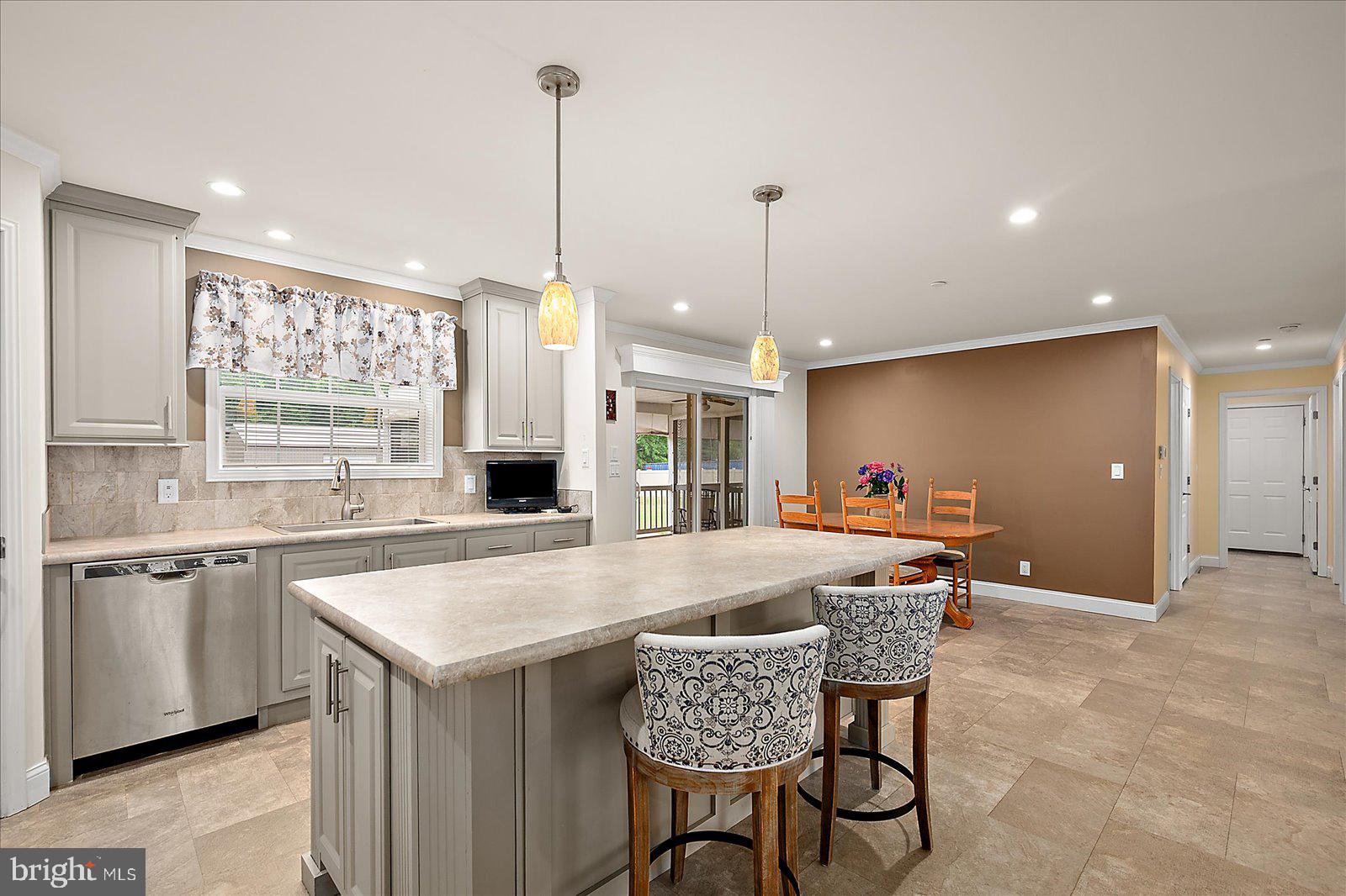 8225 Whitesville Road Pittsville, MD 21850 - Photo 12 of 45 a kitchen with a table chairs sink and wooden floor