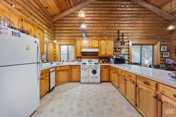 a large kitchen with stainless steel appliances granite countertop a stove and a refrigerator