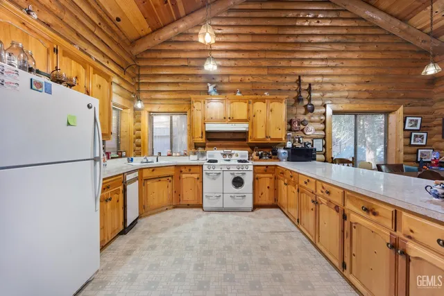 a large kitchen with stainless steel appliances granite countertop a stove and a refrigerator