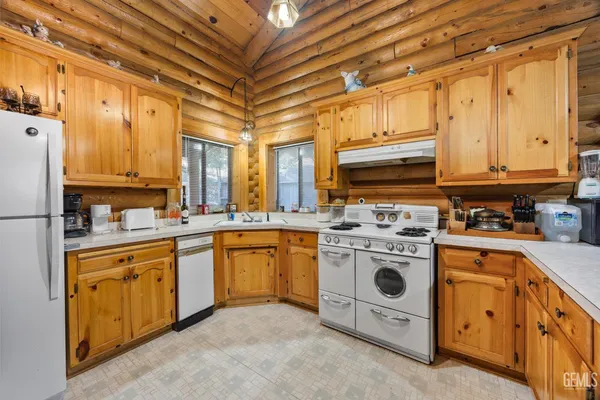 a kitchen with stainless steel appliances granite countertop a stove a sink dishwasher and a refrigerator