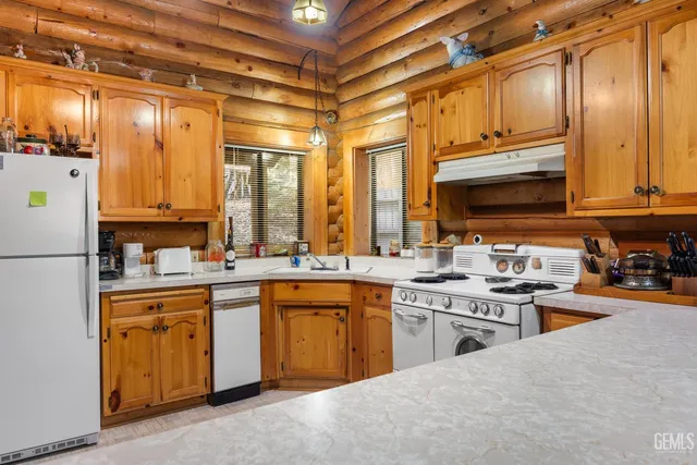 a kitchen with stainless steel appliances granite countertop a sink and cabinets