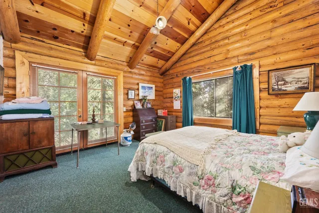 a bedroom with a bed wooden floor and window