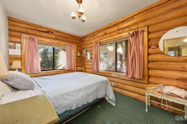 a bedroom with a bed and windows