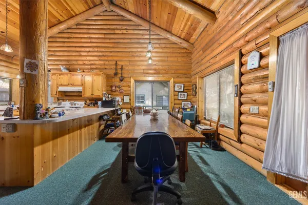 a dining room with furniture and wooden floor