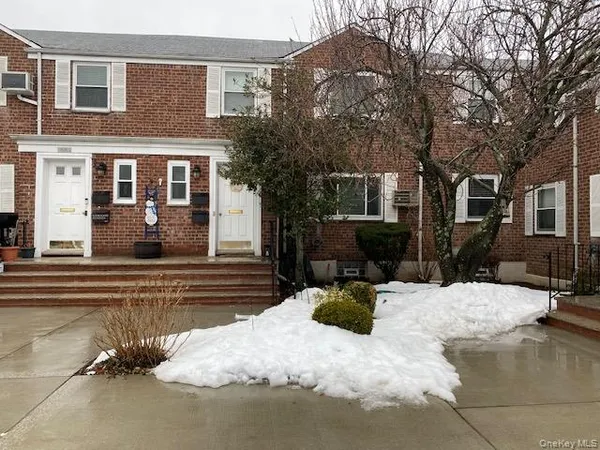 a view of a house with a yard covered in snow