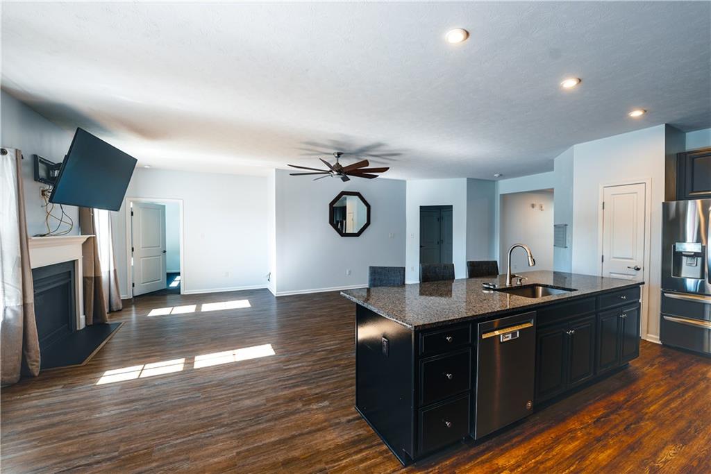 505 October Court Pittsburgh, PA 15239 - Photo 8 of 23 a kitchen with granite countertop a sink dishwasher a stove and a refrigerator with wooden floor