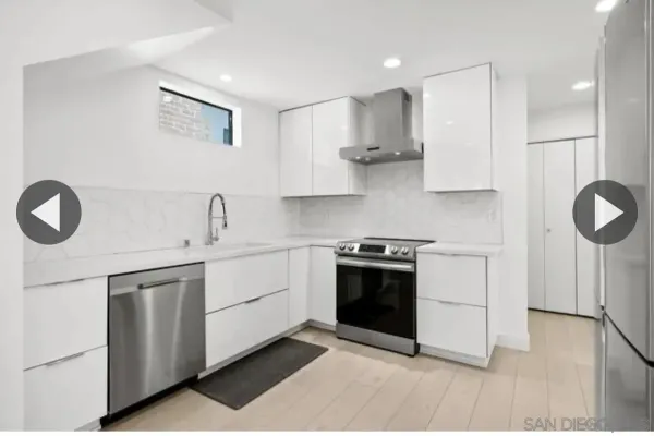 a kitchen with stainless steel appliances granite countertop a stove a sink and a refrigerator