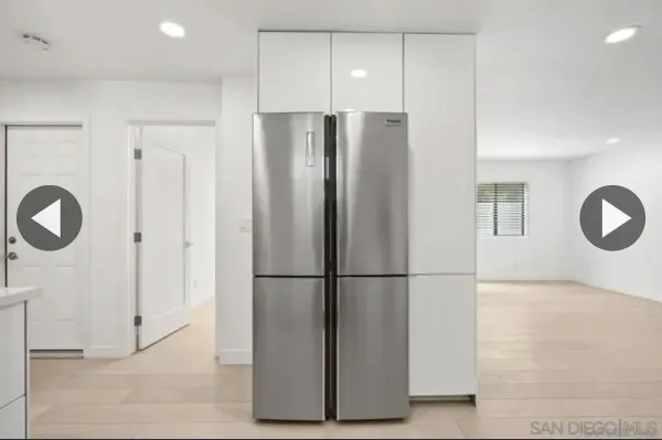 a view of a refrigerator in kitchen and furniture